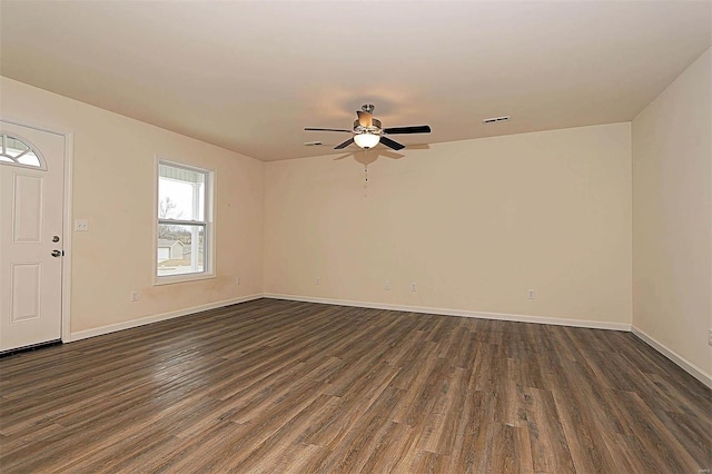 interior space featuring baseboards, dark wood-style flooring, and visible vents