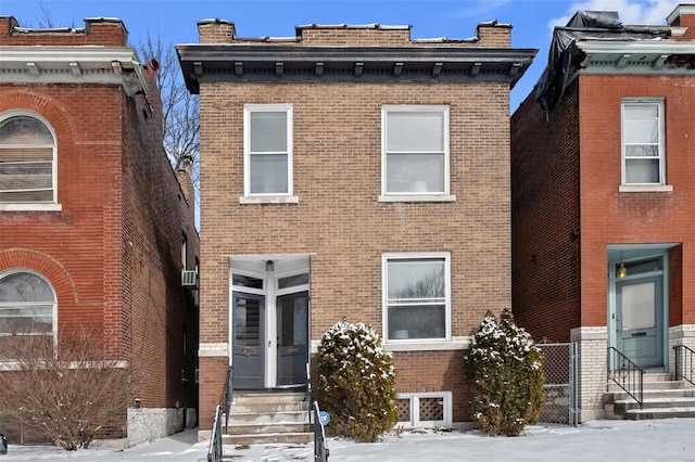 italianate house with brick siding and entry steps