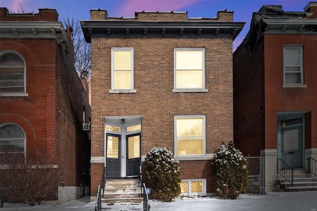 italianate house featuring entry steps and brick siding