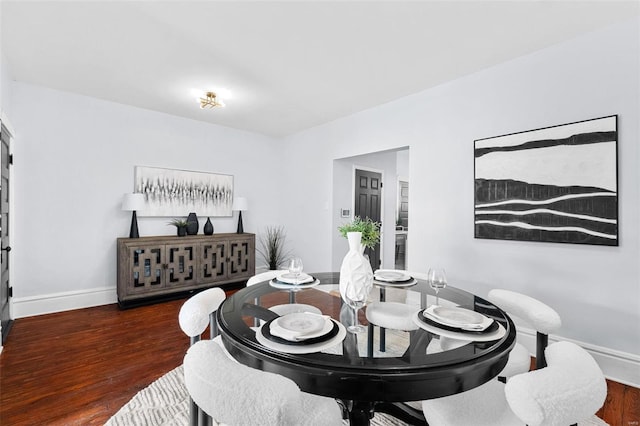 dining space with baseboards and dark wood-style floors