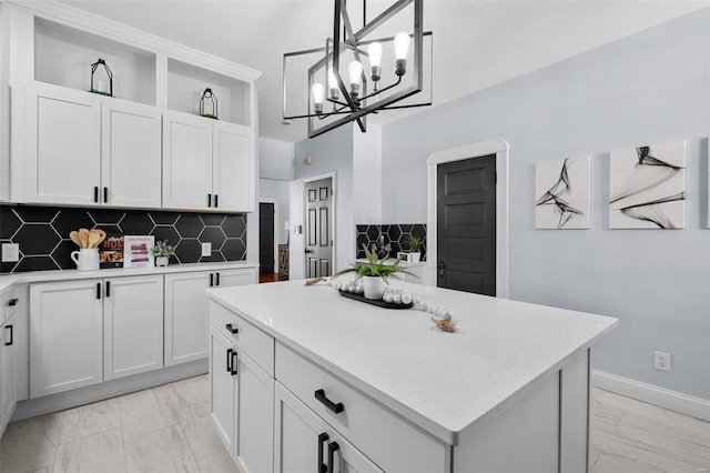 kitchen featuring white cabinetry, light countertops, a kitchen island, and open shelves