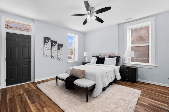 bedroom featuring baseboards, visible vents, a ceiling fan, and dark wood-style floors