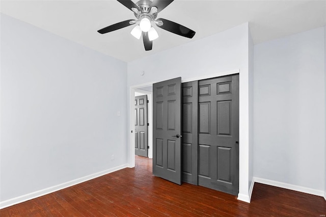 unfurnished bedroom featuring baseboards, a closet, ceiling fan, and dark wood finished floors