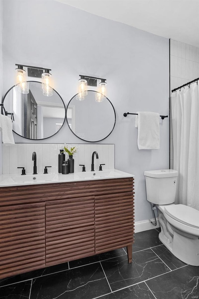 bathroom featuring baseboards, marble finish floor, a sink, toilet, and backsplash