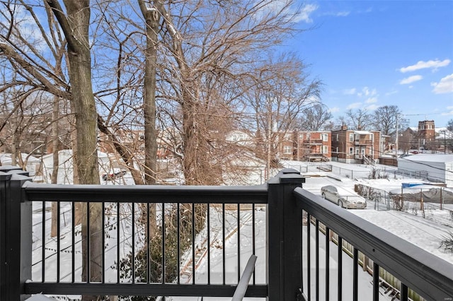 view of snow covered back of property