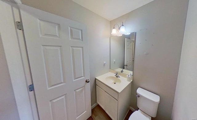 bathroom featuring toilet and vanity