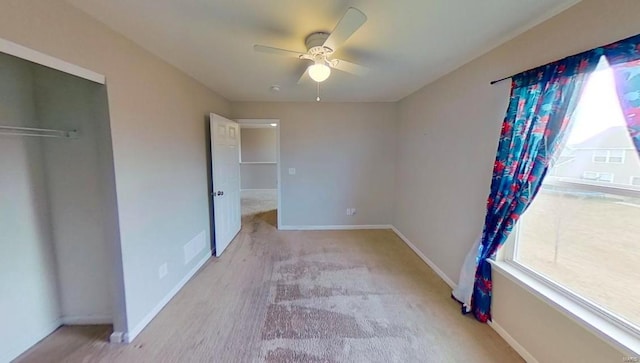 unfurnished bedroom featuring ceiling fan, baseboards, and a closet