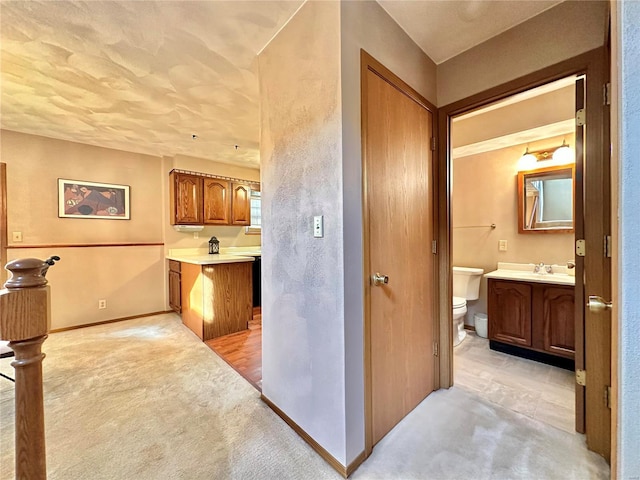 bathroom featuring vanity, toilet, and baseboards