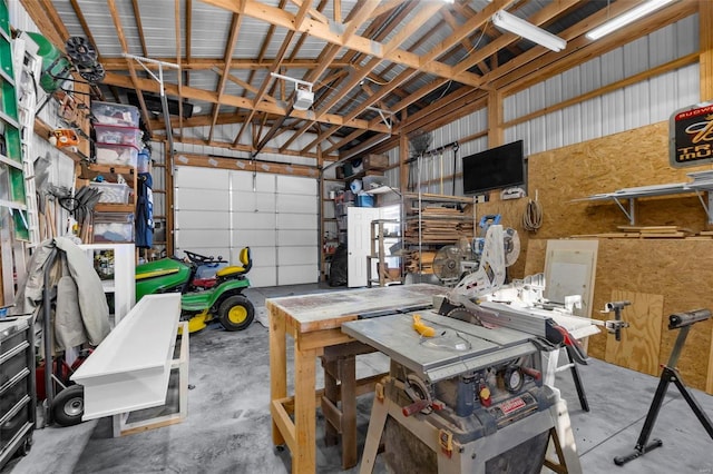 garage with a workshop area and metal wall