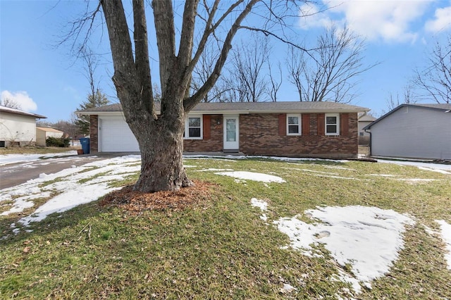 ranch-style house featuring brick siding, an attached garage, and a front yard