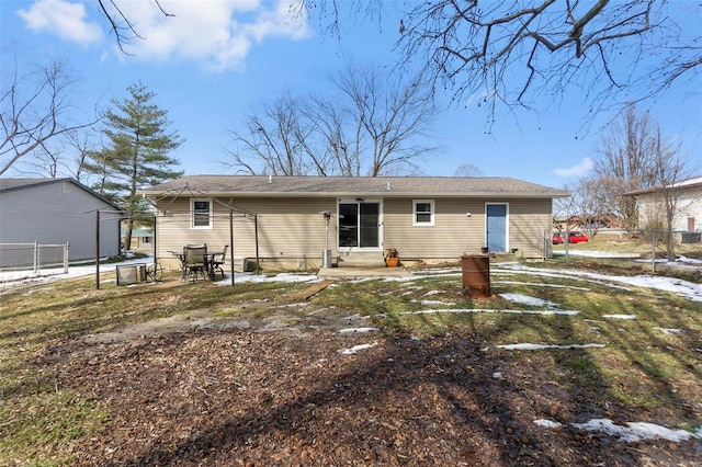 back of property featuring entry steps and fence