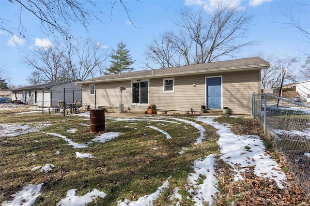 snow covered property featuring entry steps and fence