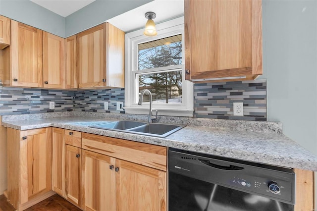 kitchen with black dishwasher, a sink, light countertops, light brown cabinets, and backsplash