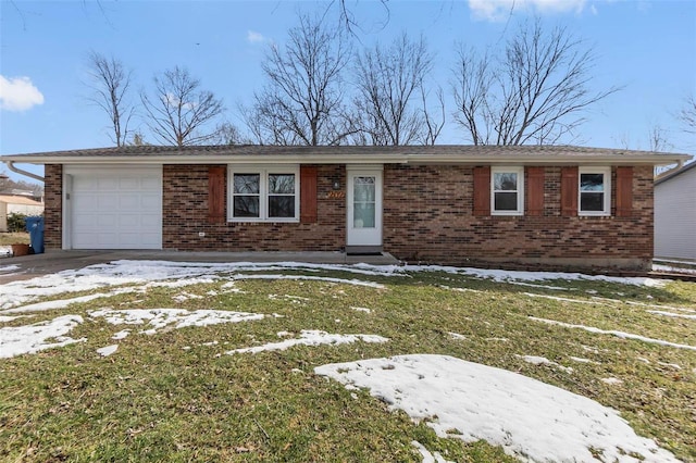 ranch-style home featuring an attached garage, a lawn, and brick siding