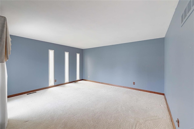 empty room with visible vents and baseboards