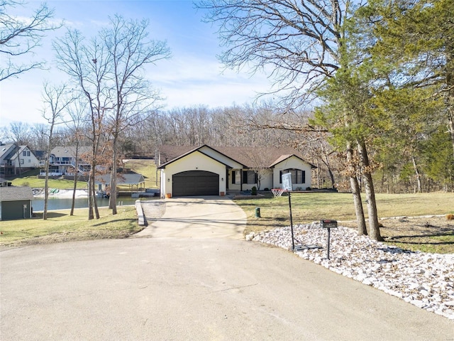 view of front of property with a garage, driveway, and a front lawn