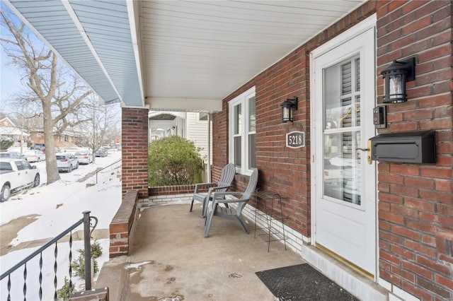 snow covered patio with covered porch