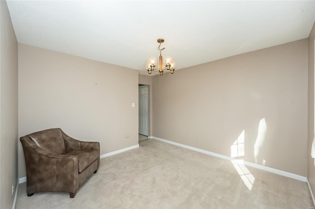 sitting room with an inviting chandelier, light colored carpet, and baseboards