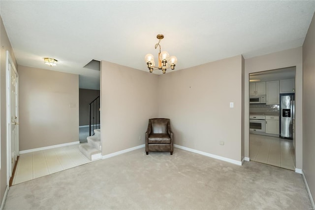 unfurnished room featuring light carpet, a chandelier, stairs, and baseboards