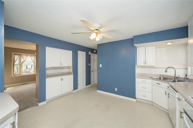 kitchen with dishwasher, light countertops, white cabinetry, a ceiling fan, and a sink