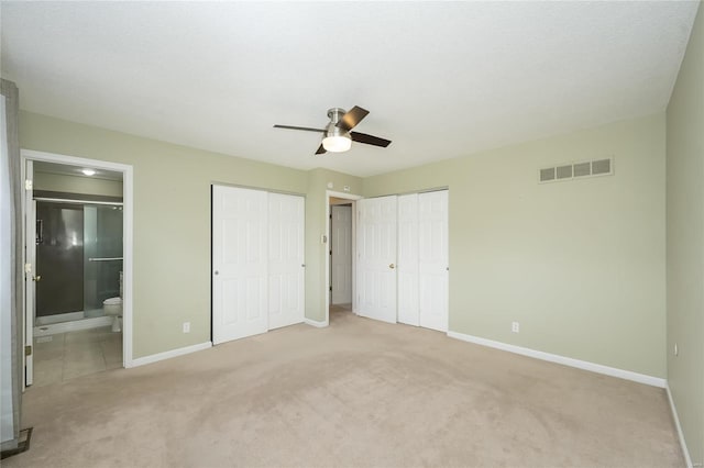 unfurnished bedroom with light colored carpet, visible vents, and baseboards