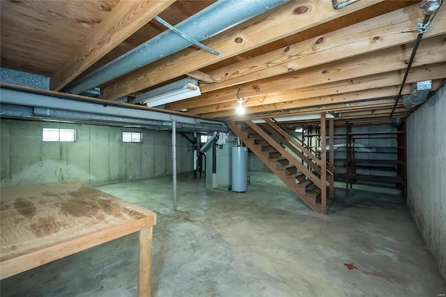 basement with gas water heater and stairs