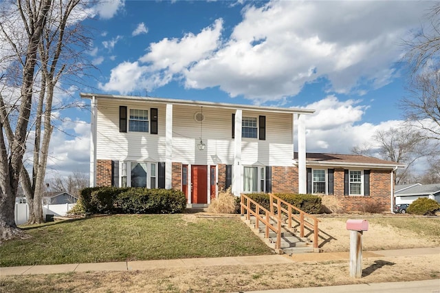 view of front of home with a front yard and brick siding