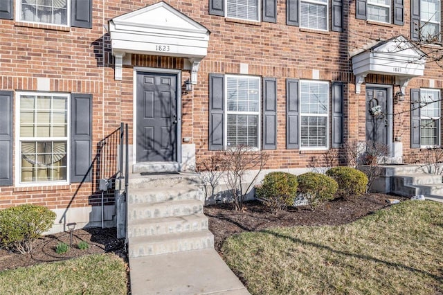 doorway to property with brick siding