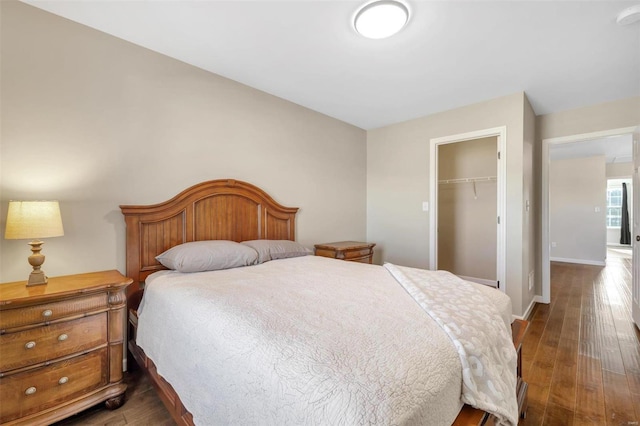 bedroom featuring a closet, baseboards, and dark wood-style floors