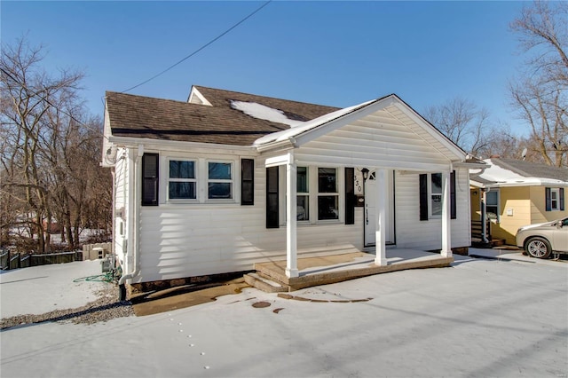 bungalow with a shingled roof and covered porch