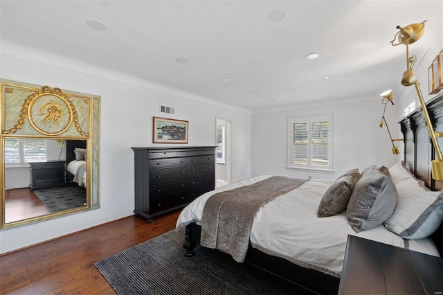 bedroom featuring dark wood-style floors, multiple windows, visible vents, and recessed lighting