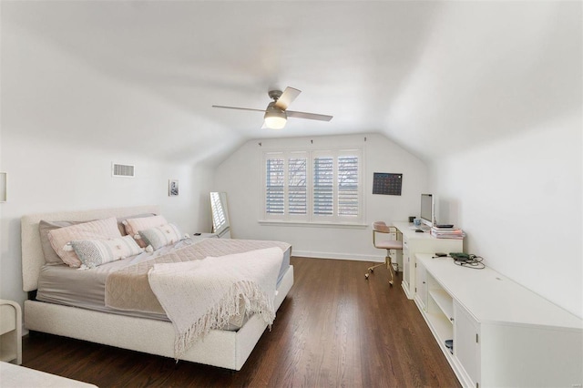 bedroom featuring dark wood-style floors, visible vents, vaulted ceiling, and a ceiling fan