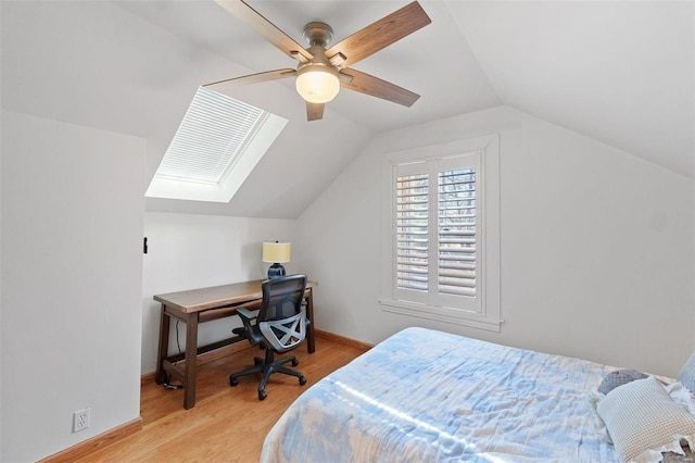 bedroom featuring lofted ceiling, light wood-style floors, baseboards, and a ceiling fan