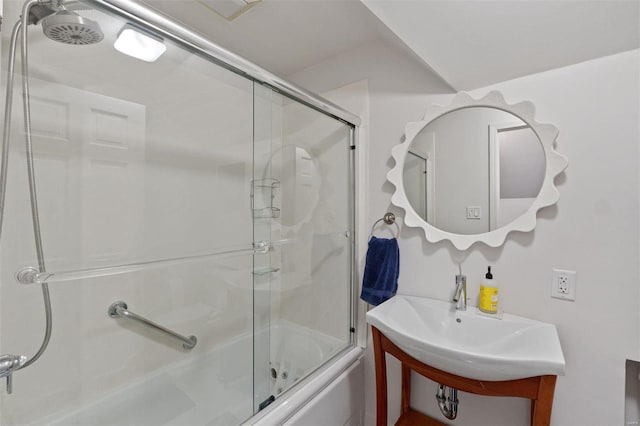 bathroom with bath / shower combo with glass door and vanity