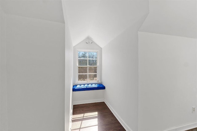 bonus room with lofted ceiling, baseboards, and wood finished floors