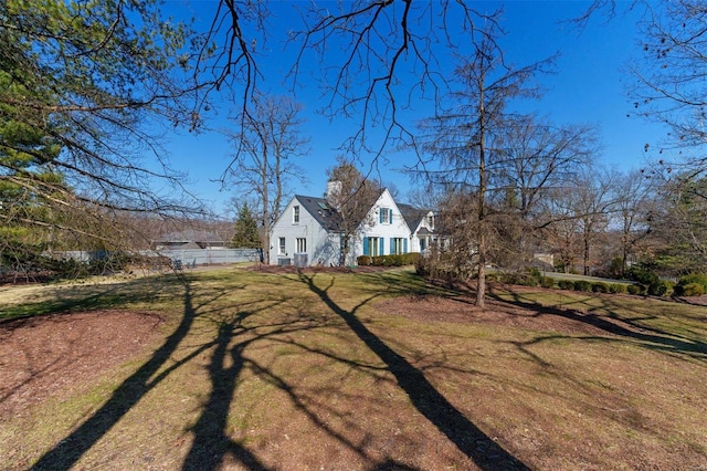 exterior space with a lawn and fence