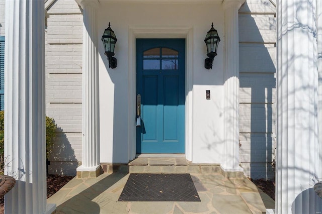 property entrance featuring brick siding