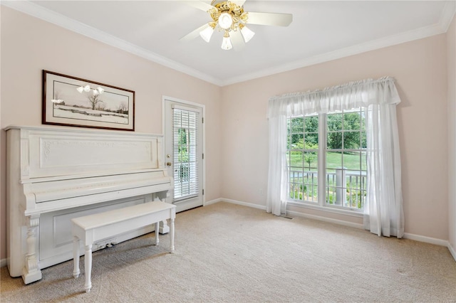 sitting room featuring baseboards, ornamental molding, a ceiling fan, and light colored carpet