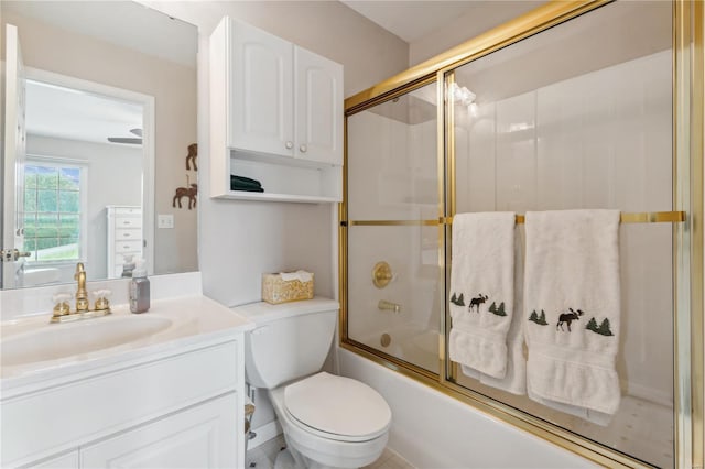 full bath featuring toilet, combined bath / shower with glass door, and vanity