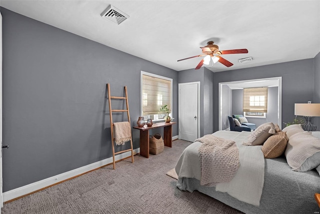 carpeted bedroom with baseboards, visible vents, and ceiling fan