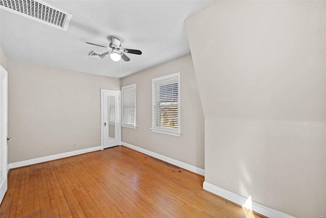 unfurnished bedroom with light wood finished floors, baseboards, visible vents, and a ceiling fan