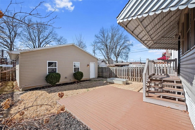 wooden terrace with fence and an outdoor structure