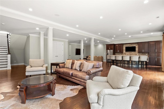 living room featuring recessed lighting, dark wood-style flooring, baseboards, stairway, and crown molding