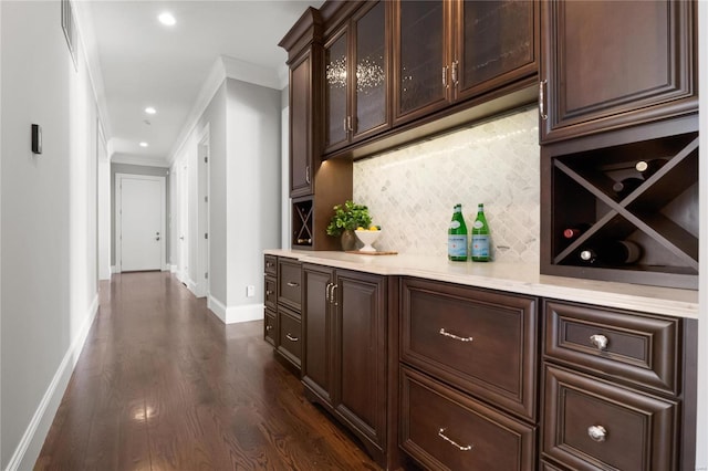 bar with recessed lighting, dark wood-style flooring, baseboards, backsplash, and crown molding