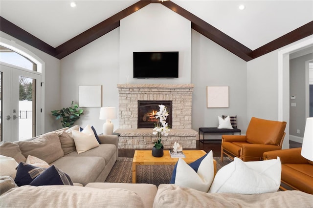 living room with baseboards, wood finished floors, a stone fireplace, french doors, and recessed lighting