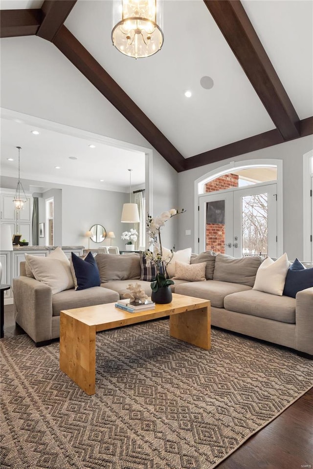 living room with dark wood-style flooring, beamed ceiling, an inviting chandelier, french doors, and high vaulted ceiling