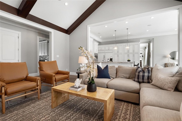 living area featuring vaulted ceiling with beams, baseboards, ornamental molding, and recessed lighting