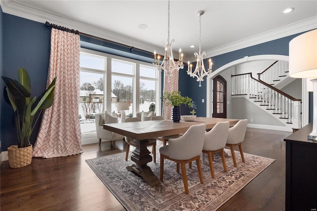 dining area with arched walkways, ornamental molding, dark wood-type flooring, and stairs