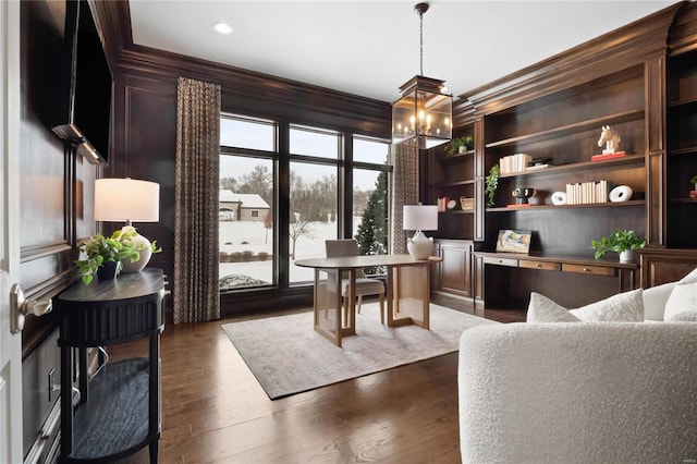 dining room with built in features, dark wood finished floors, crown molding, a notable chandelier, and recessed lighting