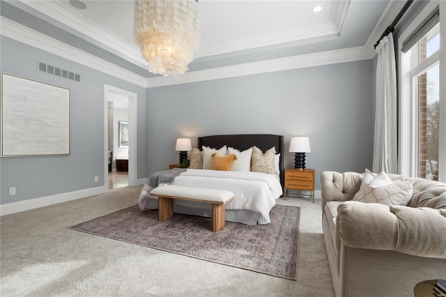 bedroom featuring a raised ceiling, visible vents, and crown molding